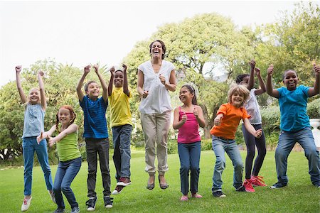 Pretty teacher jumping with pupils outside at the elementary school Stock Photo - Budget Royalty-Free & Subscription, Code: 400-07688821