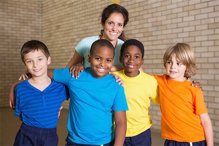 simsearch:400-07684082,k - Cute pupils smiling at camera with PE teacher at the elementary school Stock Photo - Budget Royalty-Free & Subscription, Code: 400-07688830