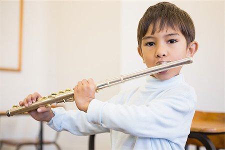 simsearch:400-07991069,k - Cute pupil playing flute in classroom at the elementary school Foto de stock - Royalty-Free Super Valor e Assinatura, Número: 400-07688890