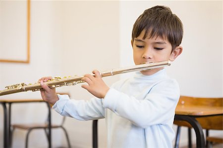 simsearch:400-07991069,k - Cute pupil playing flute in classroom at the elementary school Foto de stock - Royalty-Free Super Valor e Assinatura, Número: 400-07688891