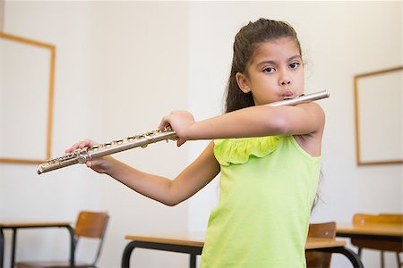 simsearch:400-07991069,k - Cute pupil playing flute in classroom at the elementary school Foto de stock - Royalty-Free Super Valor e Assinatura, Número: 400-07688909