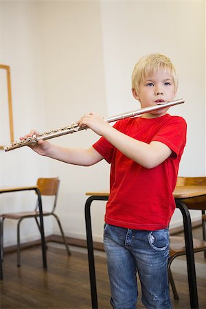 simsearch:400-07991069,k - Cute pupil playing flute in classroom at the elementary school Foto de stock - Royalty-Free Super Valor e Assinatura, Número: 400-07688914