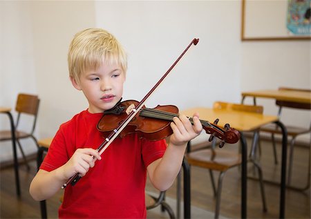 simsearch:400-07991069,k - Cute pupil playing violin in classroom at the elementary school Foto de stock - Royalty-Free Super Valor e Assinatura, Número: 400-07688912