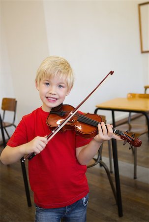 simsearch:400-07991069,k - Cute pupil playing violin in classroom at the elementary school Foto de stock - Royalty-Free Super Valor e Assinatura, Número: 400-07688913