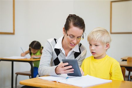 simsearch:400-07684082,k - Pretty teacher helping pupil in classroom at the elementary school Stock Photo - Budget Royalty-Free & Subscription, Code: 400-07688980