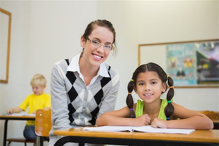 simsearch:400-07684082,k - Pretty teacher helping pupil in classroom at the elementary school Stock Photo - Budget Royalty-Free & Subscription, Code: 400-07688983