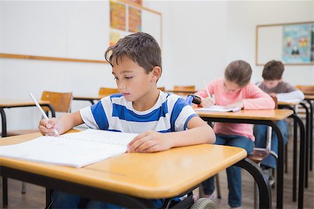 Disabled pupil writing at desk in classroom at the elementary school Stock Photo - Budget Royalty-Free & Subscription, Code: 400-07688994