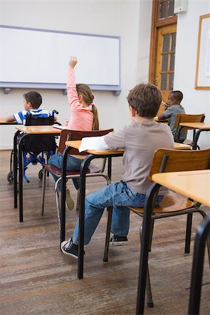simsearch:400-07991158,k - Disabled pupil writing at desk in classroom at the elementary school Stock Photo - Budget Royalty-Free & Subscription, Code: 400-07688996