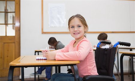 Disabled pupil smiling at camera in classroom at the elementary school Stock Photo - Budget Royalty-Free & Subscription, Code: 400-07688999