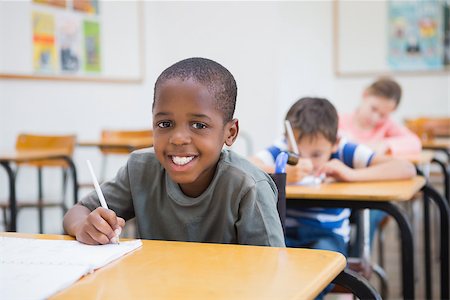 simsearch:400-07991158,k - Disabled pupil writing at desk in classroom at the elementary school Stock Photo - Budget Royalty-Free & Subscription, Code: 400-07688992