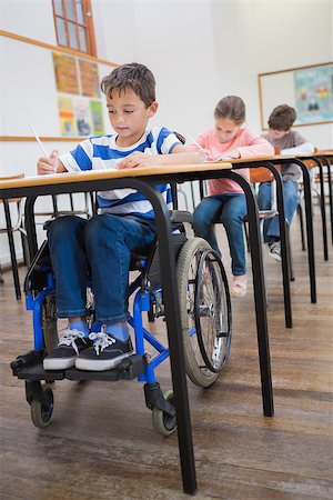 Disabled pupil writing at desk in classroom at the elementary school Stock Photo - Budget Royalty-Free & Subscription, Code: 400-07688993