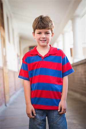 simsearch:400-07991158,k - Cute pupil smiling at camera in corridor at the elementary school Stock Photo - Budget Royalty-Free & Subscription, Code: 400-07689042