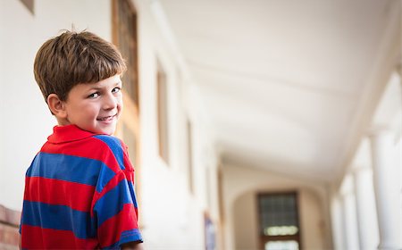 simsearch:400-07991158,k - Cute pupil smiling at camera in corridor at the elementary school Stock Photo - Budget Royalty-Free & Subscription, Code: 400-07689043