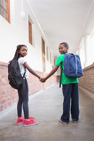 simsearch:400-07991158,k - Cute pupils holding hands in corridor at the elementary school Stock Photo - Budget Royalty-Free & Subscription, Code: 400-07689051