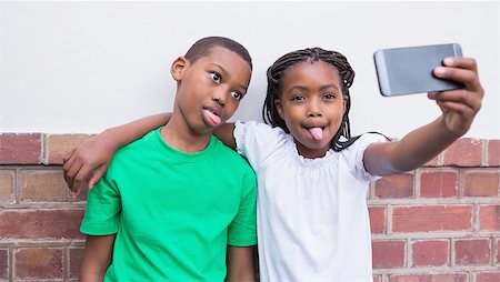 simsearch:400-07991158,k - Cute pupils taking a selfie in the corridor at the elementary school Stock Photo - Budget Royalty-Free & Subscription, Code: 400-07689065