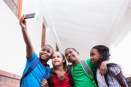 simsearch:400-07991158,k - Cute pupils taking a selfie in the corridor at the elementary school Stock Photo - Budget Royalty-Free & Subscription, Code: 400-07689069