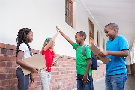 simsearch:400-07991158,k - Cute pupils high fiving in the hallway at the elementary school Stock Photo - Budget Royalty-Free & Subscription, Code: 400-07689072