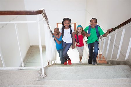 simsearch:400-07991158,k - Cute pupils smiling and walking up stairs at the elementary school Stock Photo - Budget Royalty-Free & Subscription, Code: 400-07689086