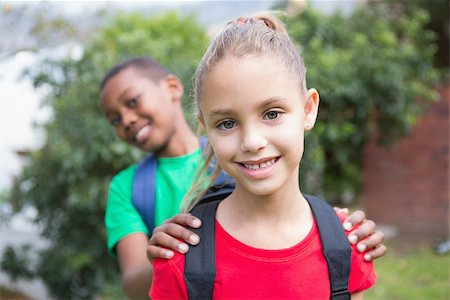 simsearch:400-07991158,k - Cute pupils smiling at camera outside at the elementary school Stock Photo - Budget Royalty-Free & Subscription, Code: 400-07689094
