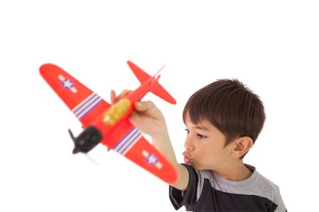 simsearch:400-07474903,k - Happy little boy playing with toy airplane on white background Foto de stock - Super Valor sin royalties y Suscripción, Código: 400-07689298