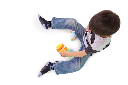 Happy little boy playing with building blocks on white background Stock Photo - Budget Royalty-Free & Subscription, Code: 400-07689300