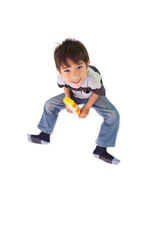 Happy little boy playing with building blocks on white background Stock Photo - Budget Royalty-Free & Subscription, Code: 400-07689301