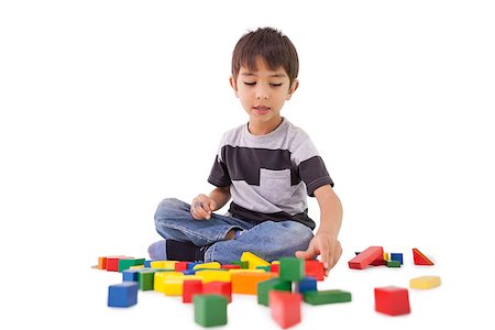 Happy little boy playing with building blocks on white background Stock Photo - Budget Royalty-Free & Subscription, Code: 400-07689303