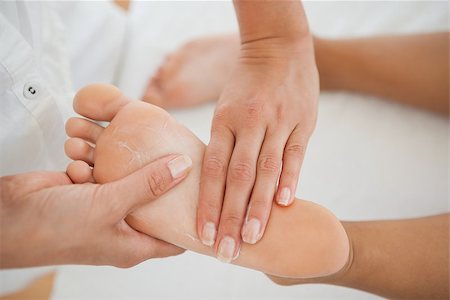 female foot massage - Woman receiving a foot massage at the health spa Photographie de stock - Aubaine LD & Abonnement, Code: 400-07689438