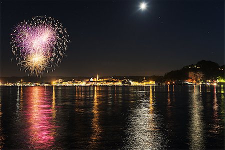 Fireworks on the lakefront of Arona in a summer party night - Piedmont Foto de stock - Royalty-Free Super Valor e Assinatura, Número: 400-07680300