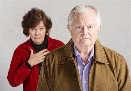 Concerned senior woman with hand on chest behind sad man Photographie de stock - Aubaine LD & Abonnement, Code: 400-07680735
