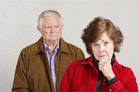 Serious woman with hand on chin with man watching Stock Photo - Budget Royalty-Free & Subscription, Code: 400-07680732