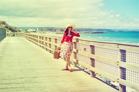 beautiful lady in red walking near the sea in retro style Stock Photo - Budget Royalty-Free & Subscription, Code: 400-07680799