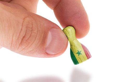 senegal people - Hand holding wooden pawn with a flag painting, selective focus, Senegal Stock Photo - Budget Royalty-Free & Subscription, Code: 400-07680915