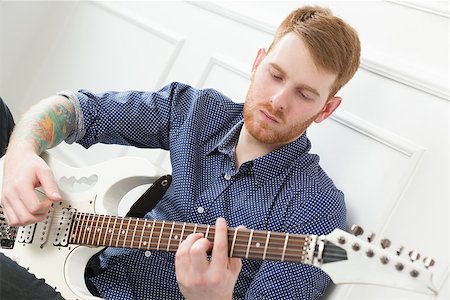 simsearch:400-07680948,k - Handsome guy on the floor with electric guitar Stock Photo - Budget Royalty-Free & Subscription, Code: 400-07680947