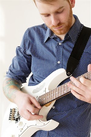 simsearch:400-07680948,k - Handsome man playing on guitar Stock Photo - Budget Royalty-Free & Subscription, Code: 400-07680951