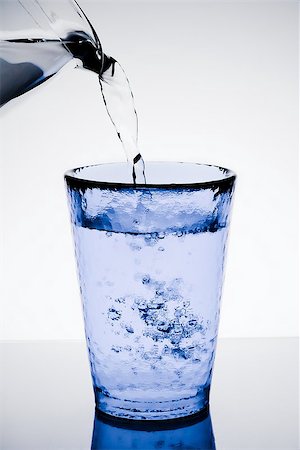 simsearch:400-06918144,k - filling a blue glass with pure water and bubbles on table Stock Photo - Budget Royalty-Free & Subscription, Code: 400-07681028