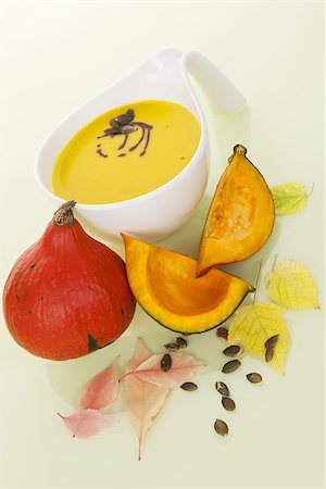 Culinary hokkaido pumpkin soup with hokkaido pumpkin, sees and leaves. Delicious seasonal autumn soup eating. Stock Photo - Budget Royalty-Free & Subscription, Code: 400-07681081