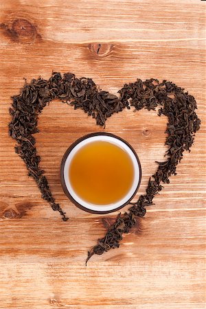 simsearch:400-08186432,k - Green tea leaves in heart shape with cup of tea on wooden background. I love tea concept. Stock Photo - Budget Royalty-Free & Subscription, Code: 400-07681118