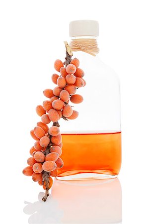 Sea buckthorn oil in glass bottle and fresh berries with frost isolated on white background. Healthy alternative medicine. Stock Photo - Budget Royalty-Free & Subscription, Code: 400-07681124