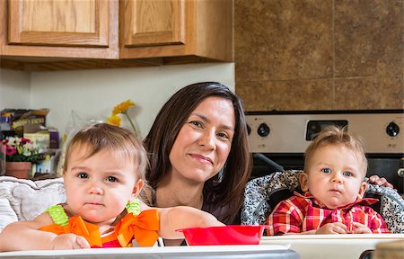 A mother in the kitchen poses with babies Stock Photo - Budget Royalty-Free & Subscription, Code: 400-07682079