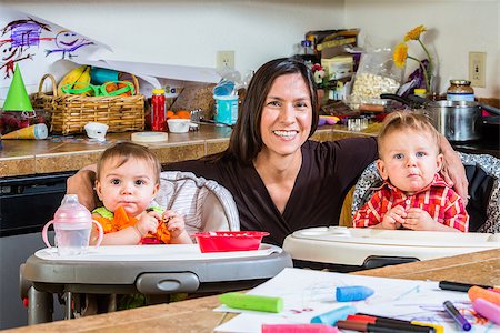 Smiling mother poses with her babies Stock Photo - Budget Royalty-Free & Subscription, Code: 400-07682090