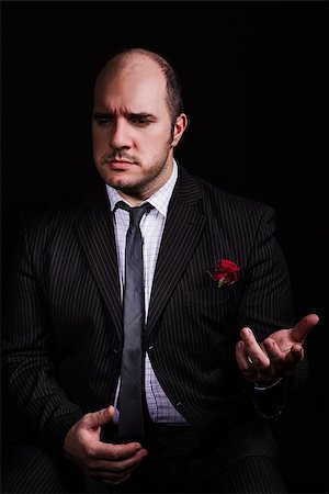 Portrait of man, godfather-like character. Studio shpt, black background. Stock Photo - Budget Royalty-Free & Subscription, Code: 400-07682369