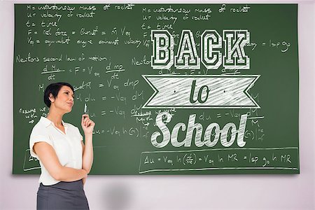 simsearch:400-07682840,k - Thoughtful businesswoman against black chalkboard Fotografie stock - Microstock e Abbonamento, Codice: 400-07682870