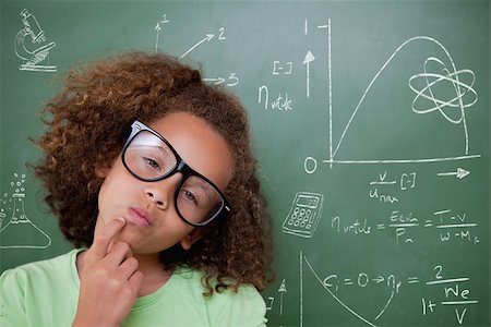 simsearch:400-07682840,k - Cute pupil thinking against math and science doodles Fotografie stock - Microstock e Abbonamento, Codice: 400-07683137