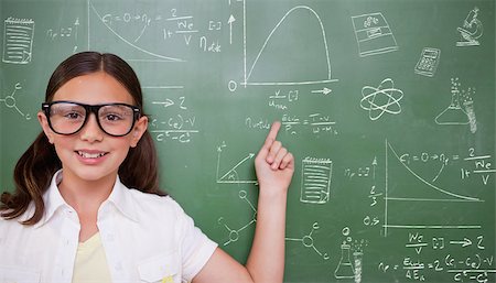 simsearch:400-07682840,k - Cute pupil pointing against math and science doodles Fotografie stock - Microstock e Abbonamento, Codice: 400-07683132