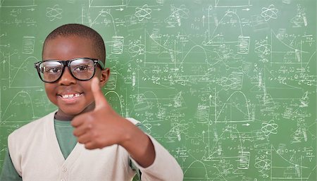 simsearch:400-07682840,k - Cute pupil showing thumbs up against math and science doodles Fotografie stock - Microstock e Abbonamento, Codice: 400-07683133