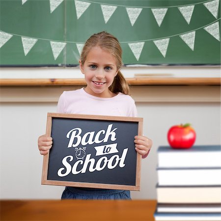 school girl holding pile of books - Back to school message against cute pupil showing chalkboard Stock Photo - Budget Royalty-Free & Subscription, Code: 400-07683419