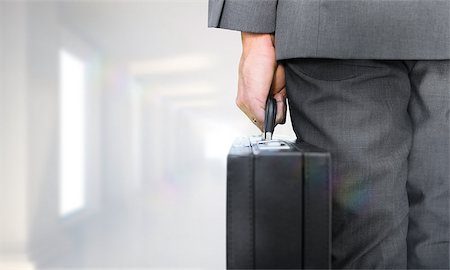 simsearch:400-08020381,k - Businessman holding briefcase against digitally generated room Fotografie stock - Microstock e Abbonamento, Codice: 400-07683661