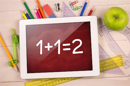 simsearch:400-07682840,k - Composite image of digital tablet on students desk showing math equations Fotografie stock - Microstock e Abbonamento, Codice: 400-07683776