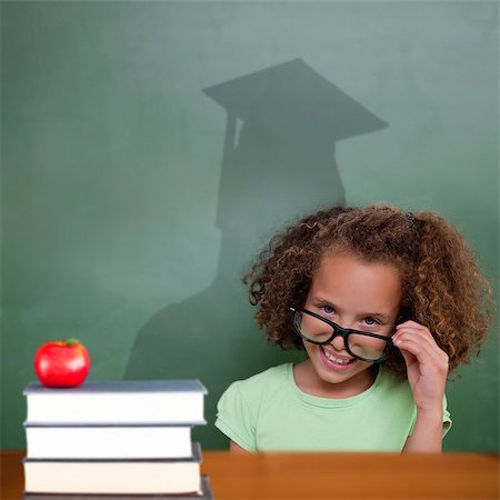Composite image of cute pupil with graduate shadow in classroom Stock Photo - Budget Royalty-Free & Subscription, Code: 400-07683944